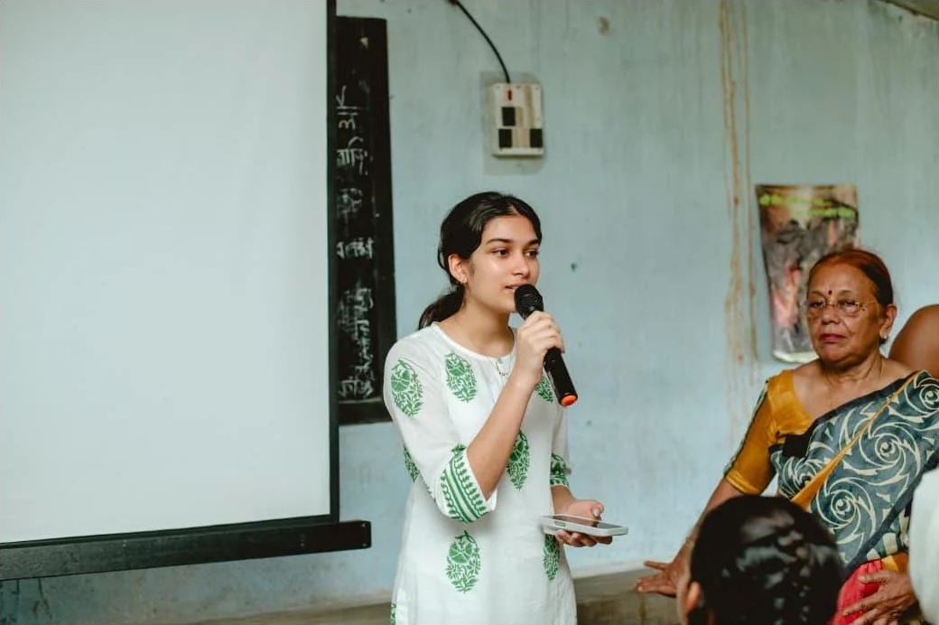 Aanya speaking with women in the community